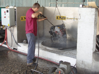 parts washing station with guy washing an engine